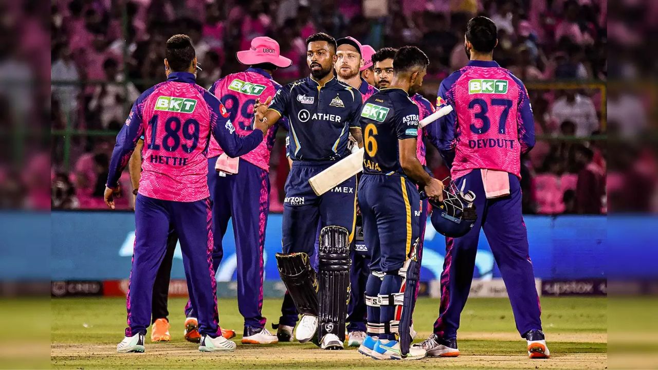 rajasthan royal player and gujrat titans player shaking hand in ground