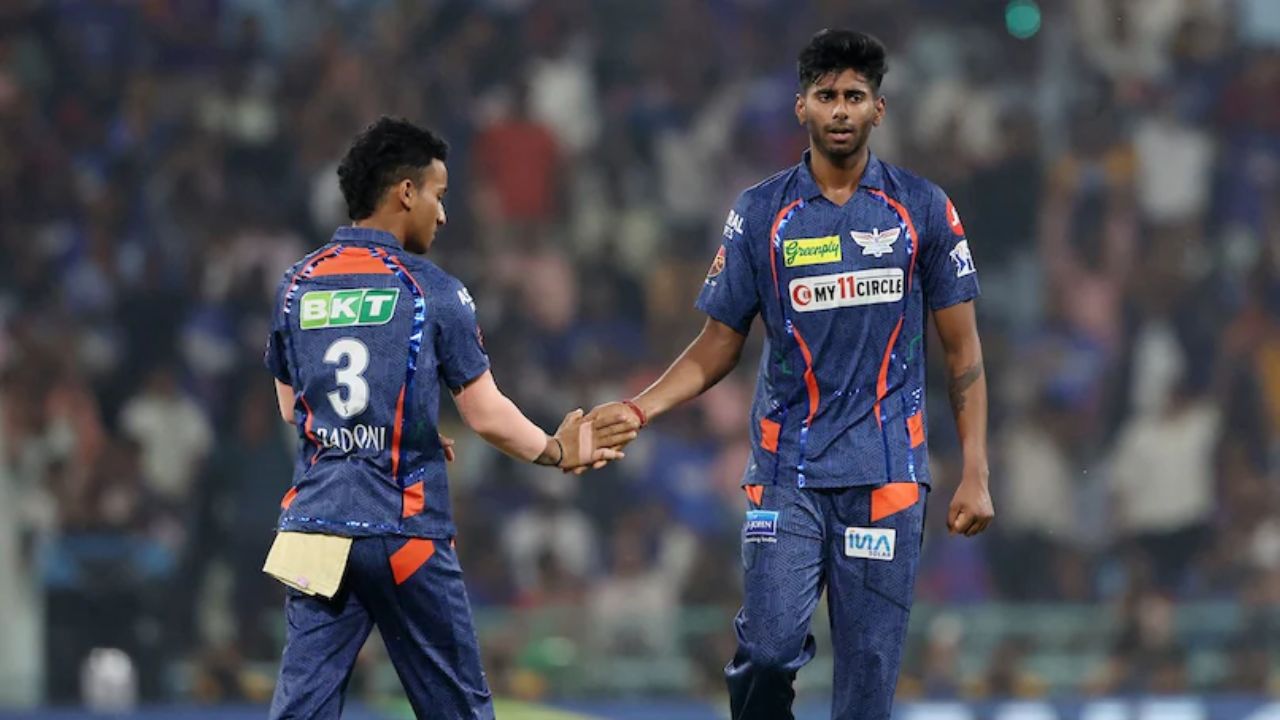 mayank yadav and aayush badoni in lsg jersey in a ipl match on ground